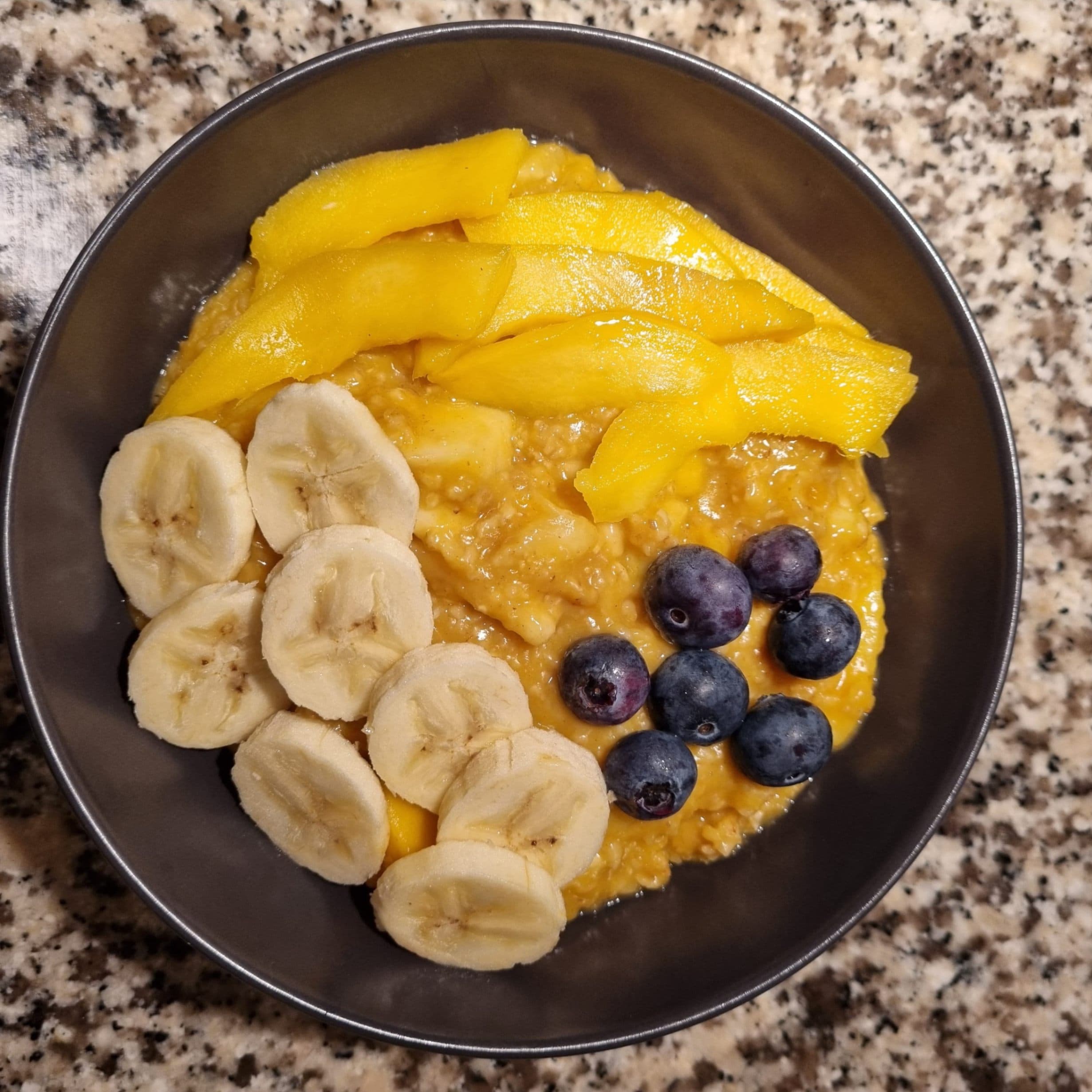 Yellow Porridge with Mango, Banana, and Blueberries Rocely Recipe